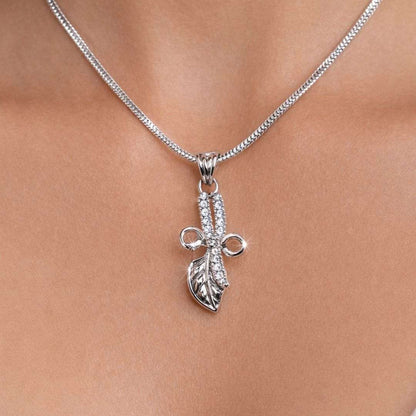Silver necklace with a leaf pendant on a person's neck