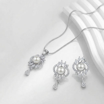 Silver necklace and earring set with central pearls and surrounding crystal accents