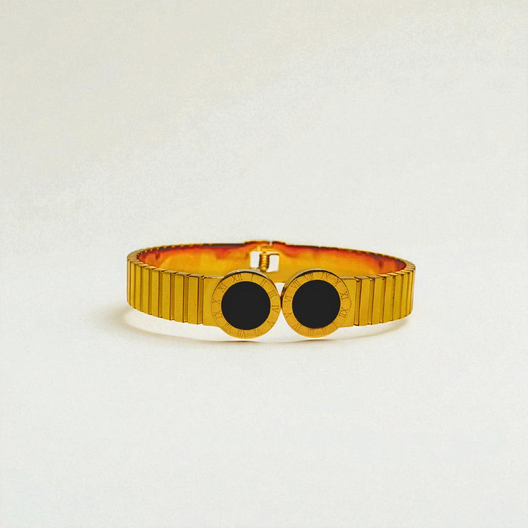 Gold Bracelet for Women with black stones on a light gray background