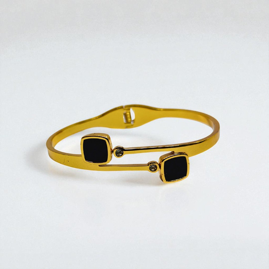 Gold Bracelet for Women with black square stones on a white background