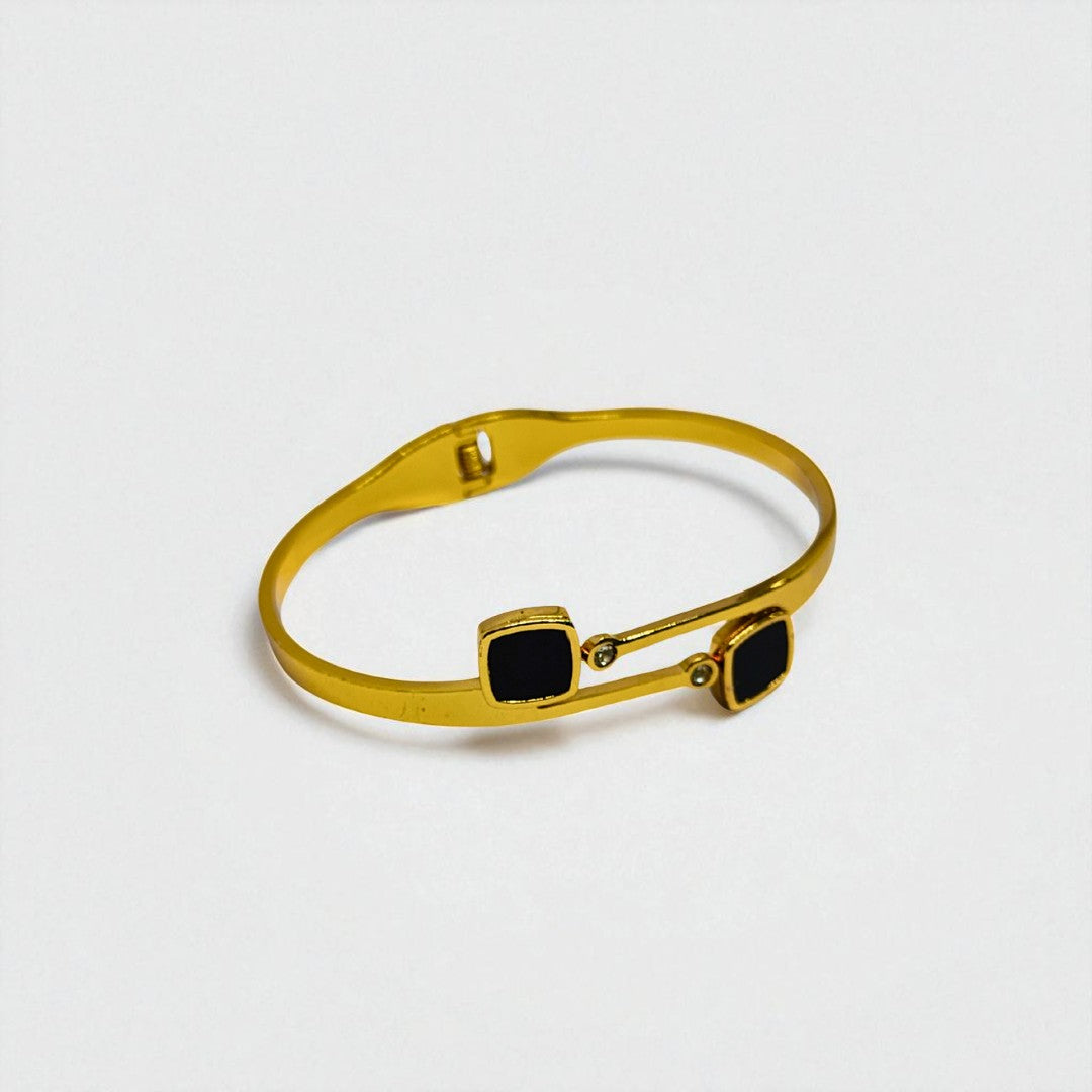 Gold Bracelet for Women with black square stones on a light gray background