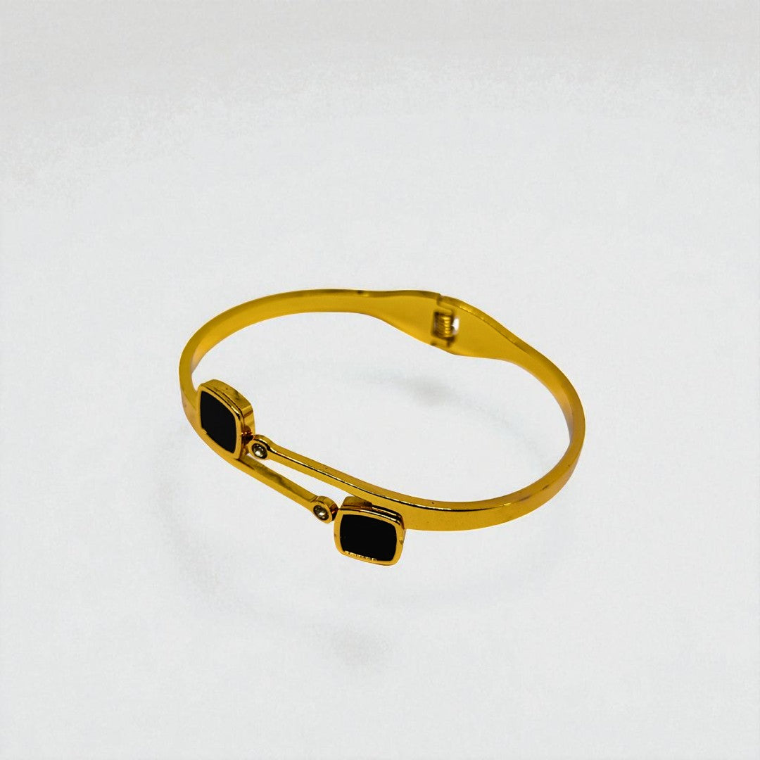 Gold Bracelet for Women with black square stones on a light gray background