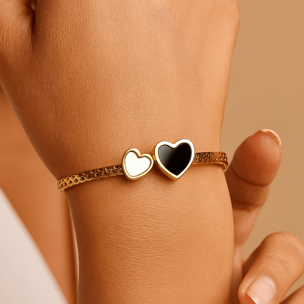 Hand wearing a Bracelet for Women with heart-shaped charms on a beige background