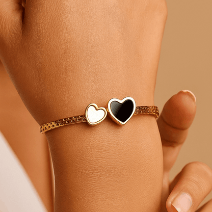 Hand wearing a Bracelet for Women with heart-shaped charms on a beige background
