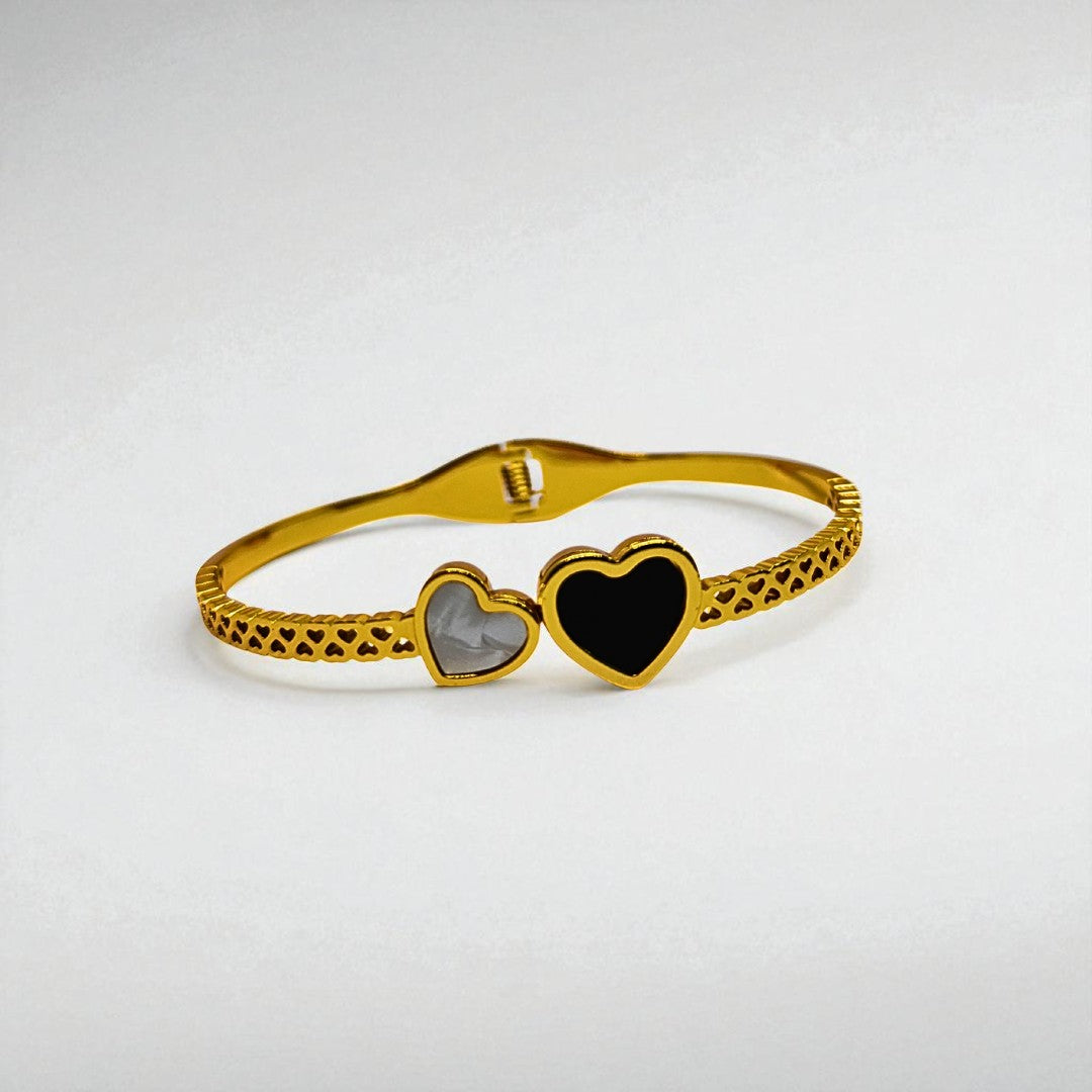 Gold Bracelet for Women with heart-shaped charms on a light gray background