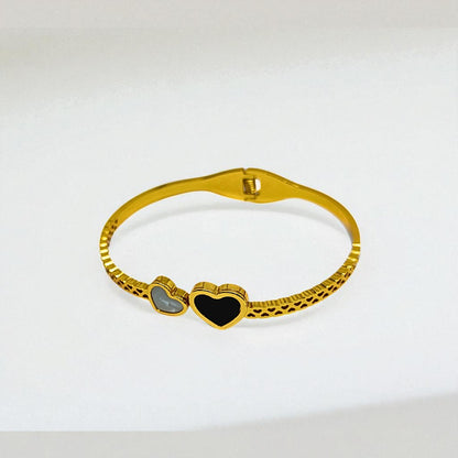 Gold Bracelet for Women with heart-shaped charms on a white background