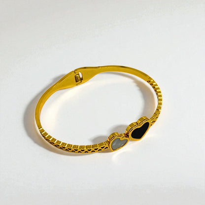 Gold Bracelet for Women with a heart-shaped gemstone on a light gray background