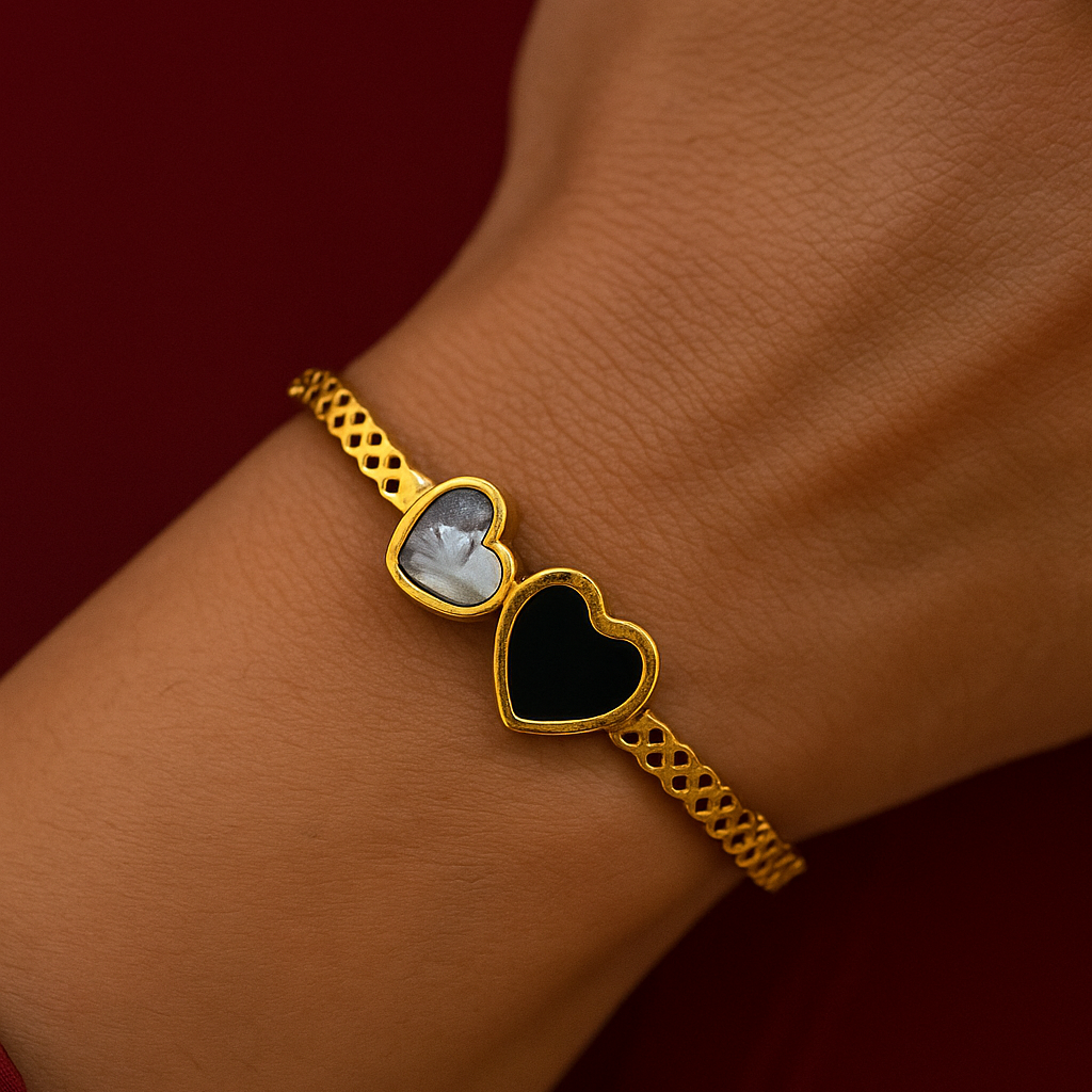 Gold Bracelet for Women with heart-shaped charms on a wrist against a red background