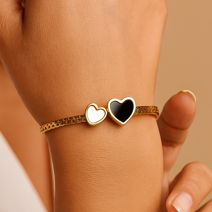 Hand wearing a Bracelet for Women with heart-shaped charms on a beige background