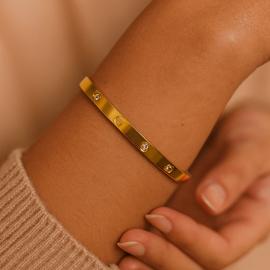 Gold Earrings for Womenon a wrist with a neutral background