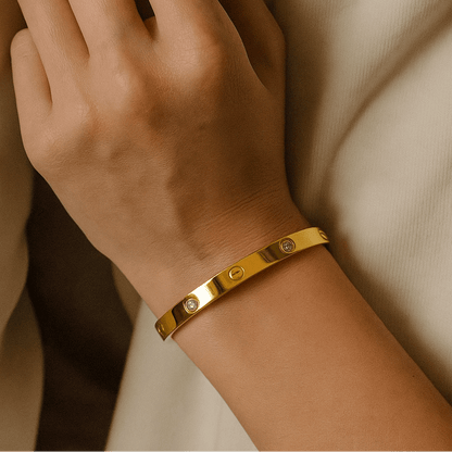 Gold Bracelet for Women on a wrist with a neutral background