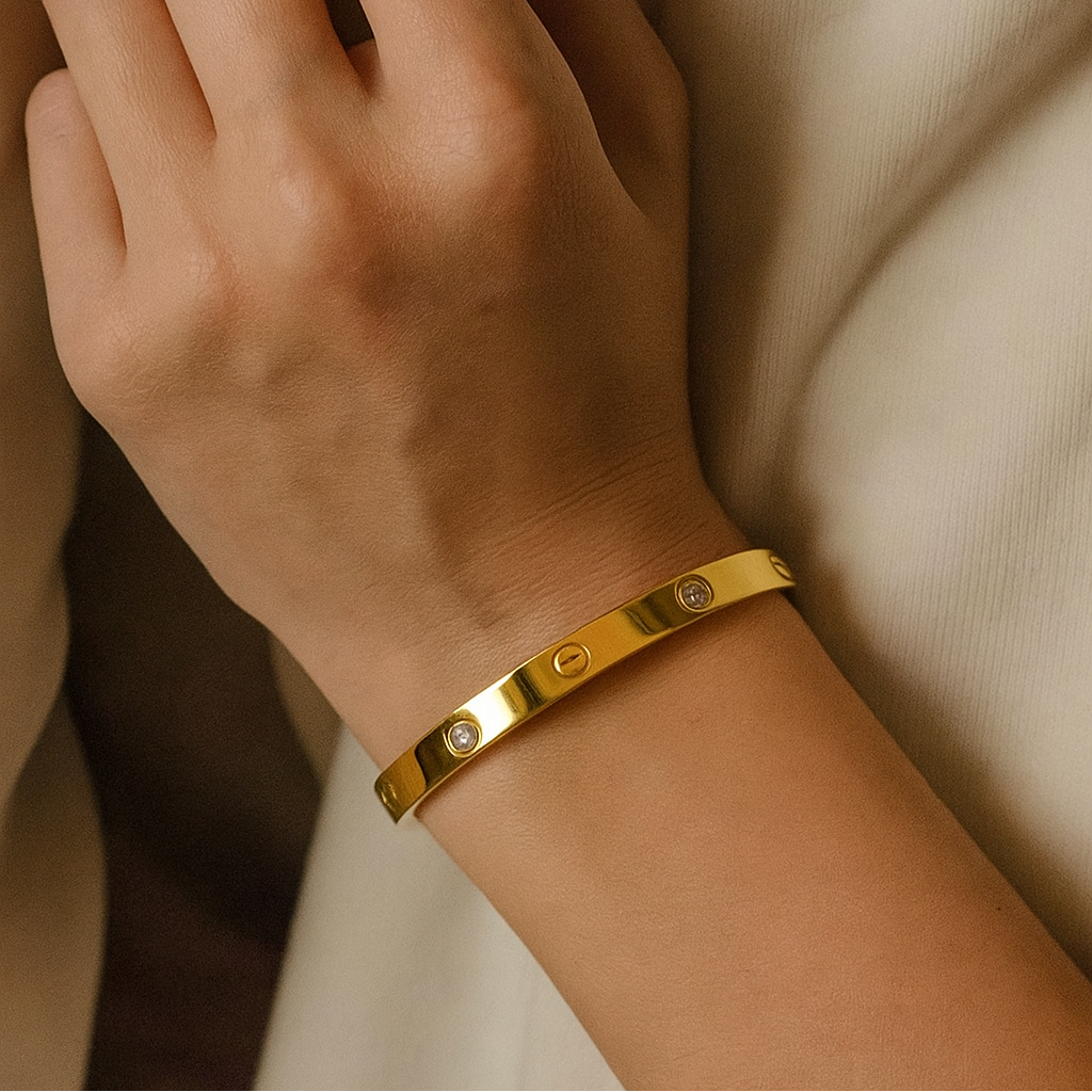Gold Bracelet for Women on a wrist with a neutral background
