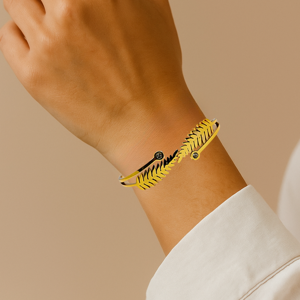 Hand wearing a Gold Bracelet for Women on a beige background
