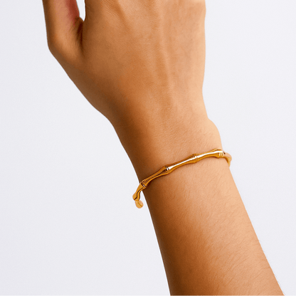 Gold Bracelet for Women on a wrist against a light gray background
