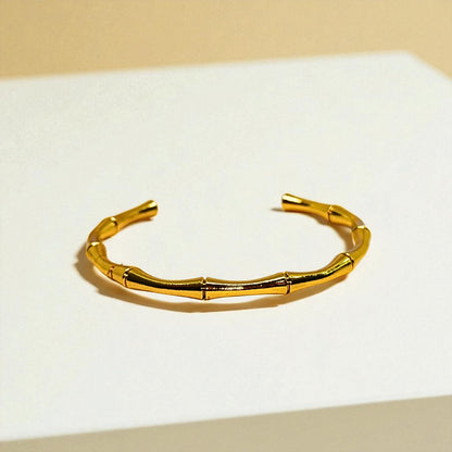 Gold Bracelet for Women on a white surface with a beige background