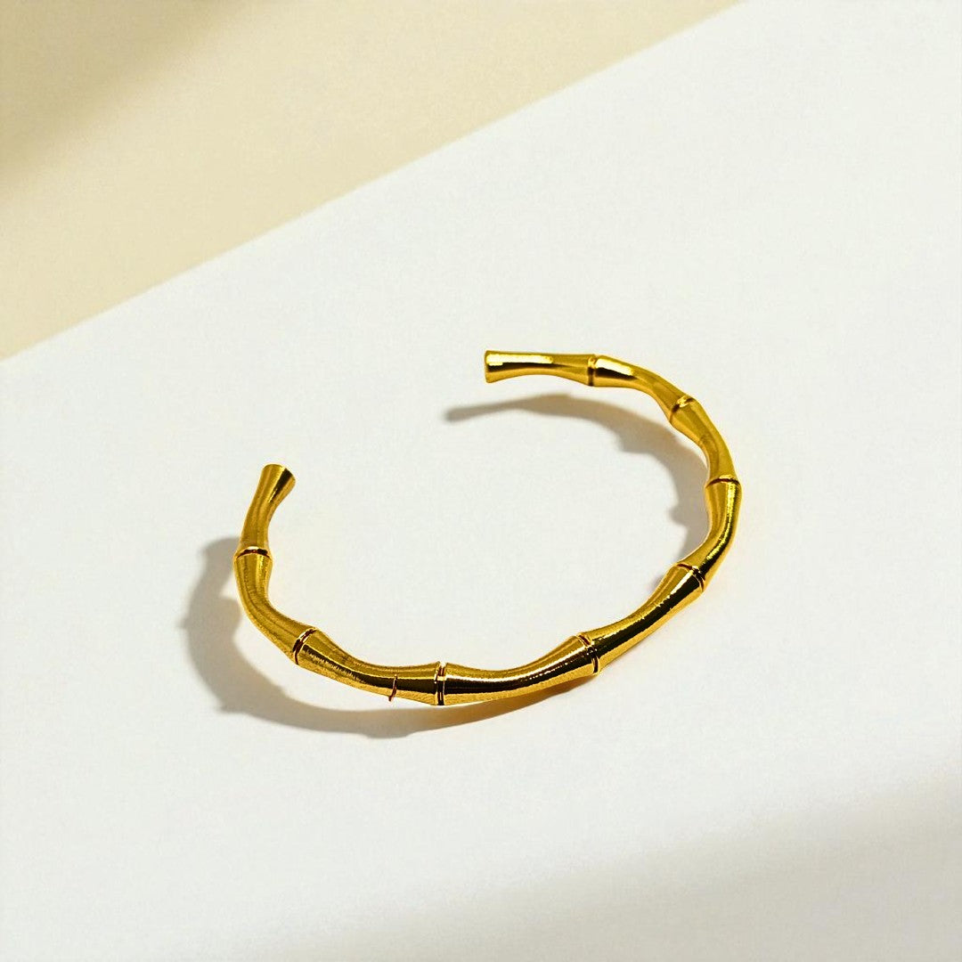 Gold Bracelet for Women on a white surface with a beige background