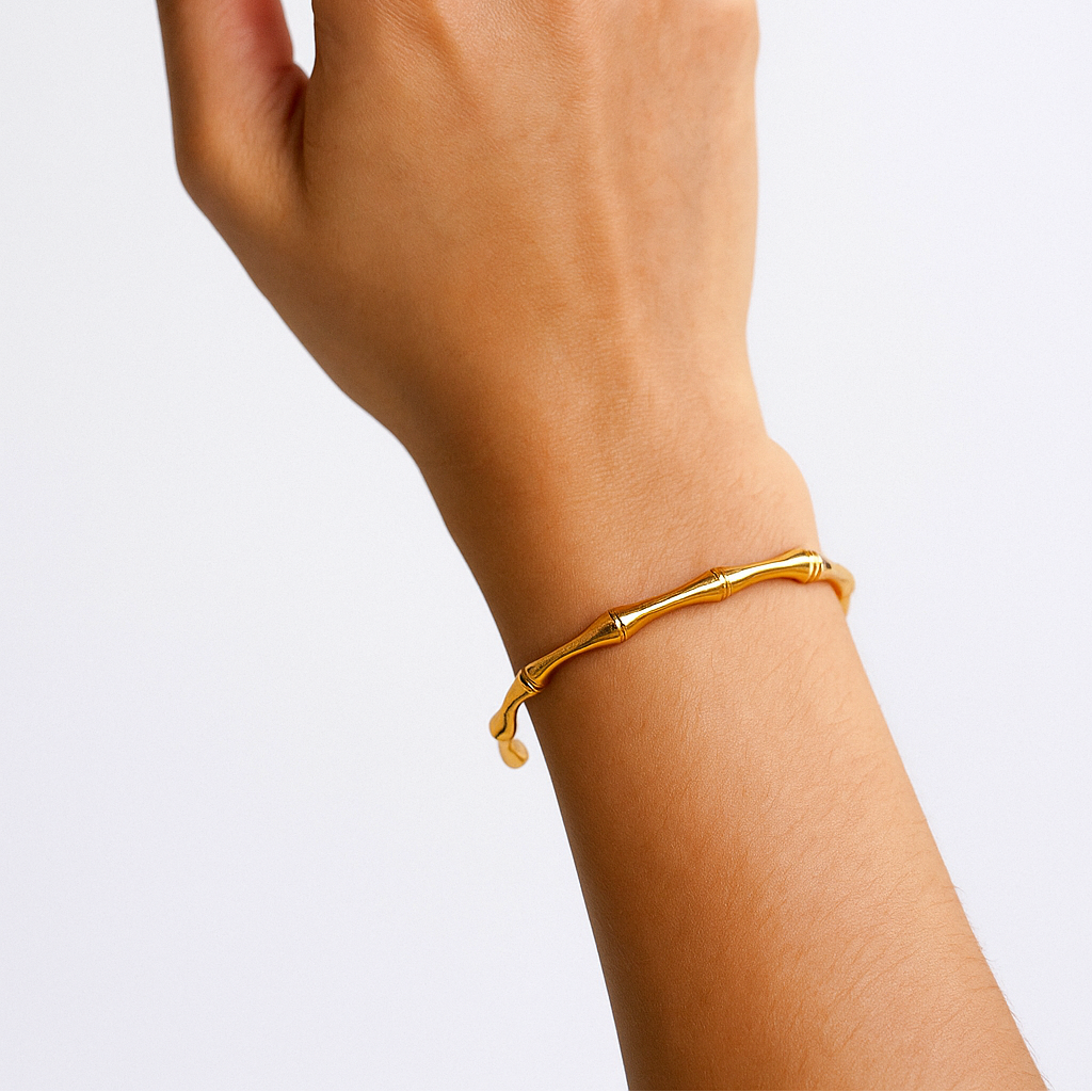 Gold Bracelet for Women on a wrist against a light gray background