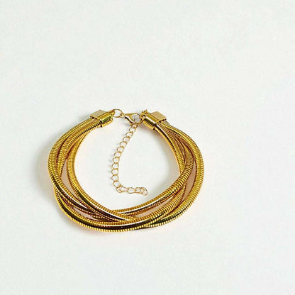 Gold Bracelet for Women on a wrist with a neutral background