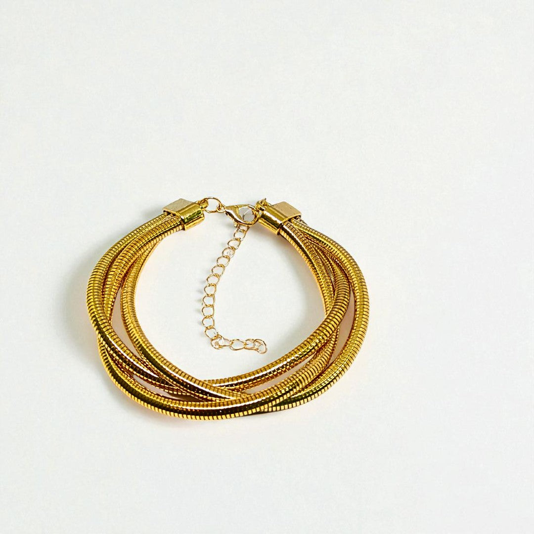 Gold Bracelet for Women on a wrist with a neutral background