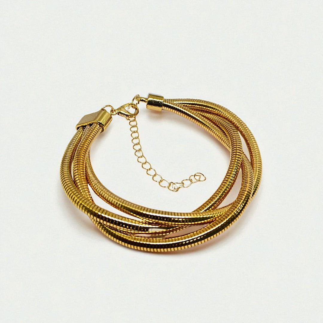 Gold Bracelet for Women on a wrist with a neutral background
