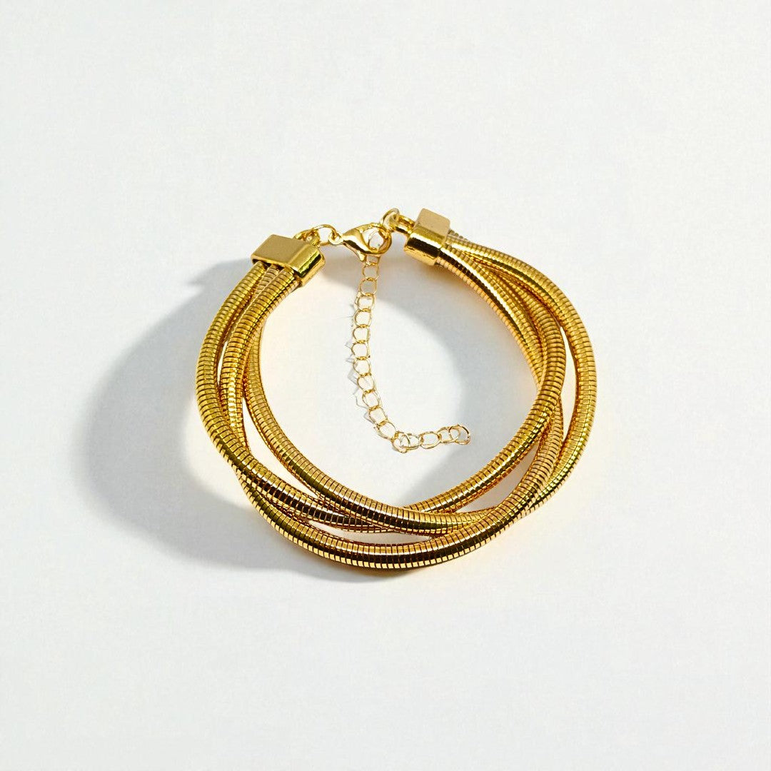 Gold Bracelet for Women on a wrist with a neutral background