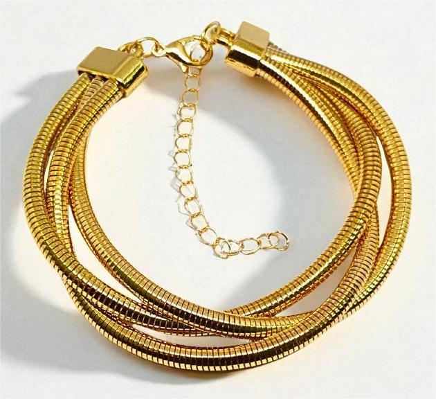 Gold Bracelet for Women with multiple braided strands on a white background