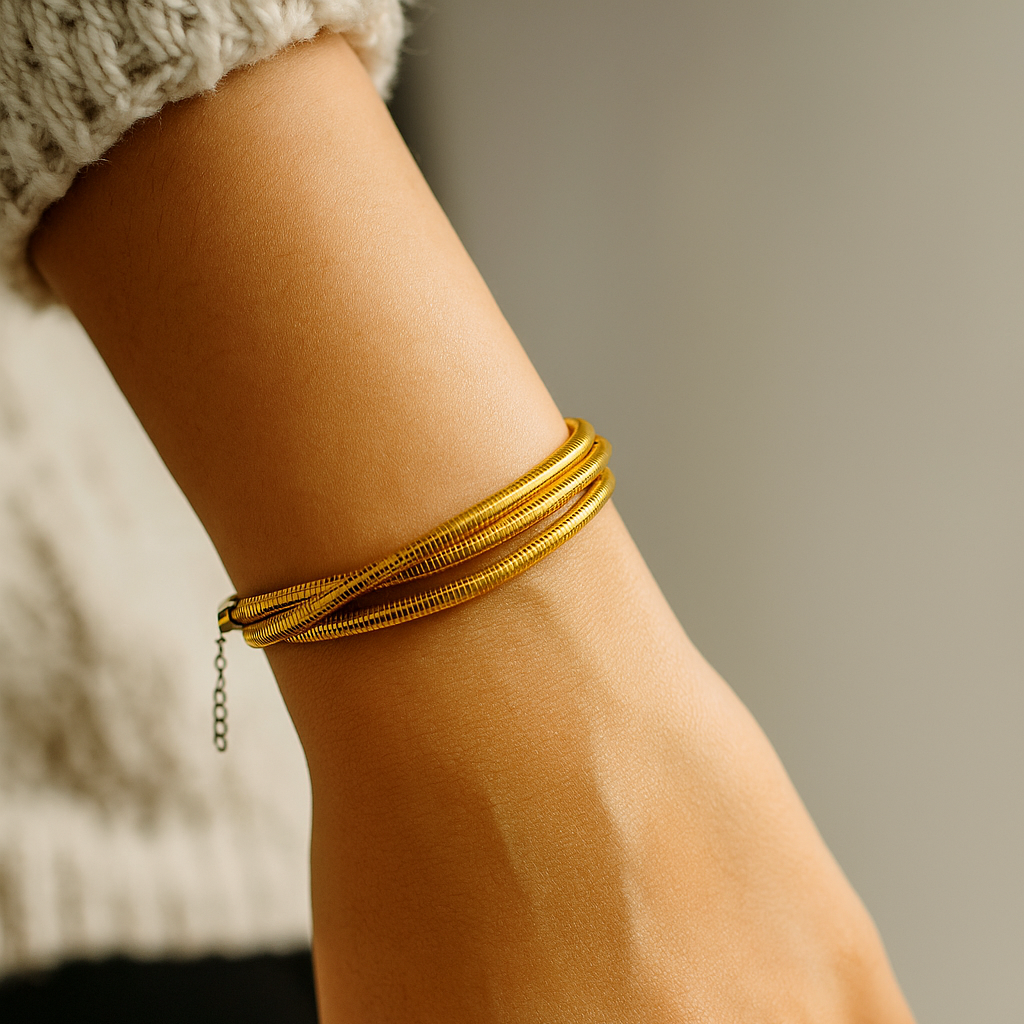 Gold Bracelet for Women on a wrist with a neutral background