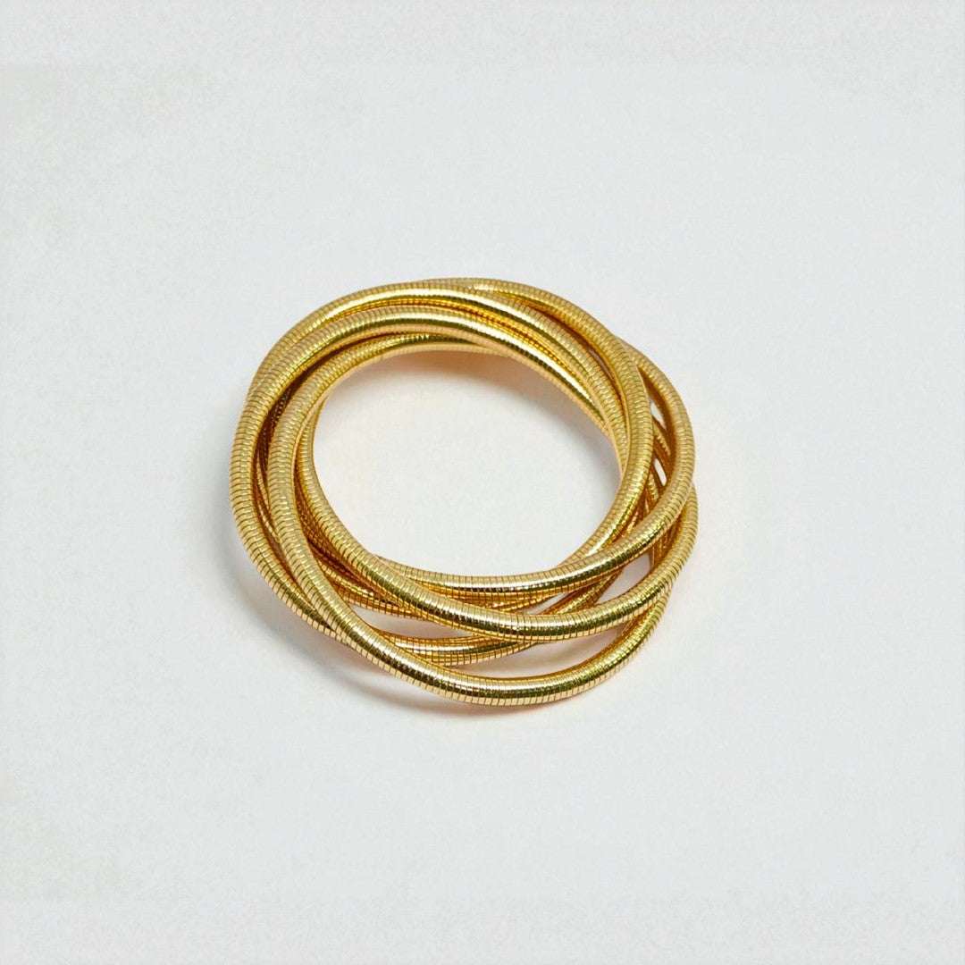 Gold Bracelet for Women stacked on a light gray background