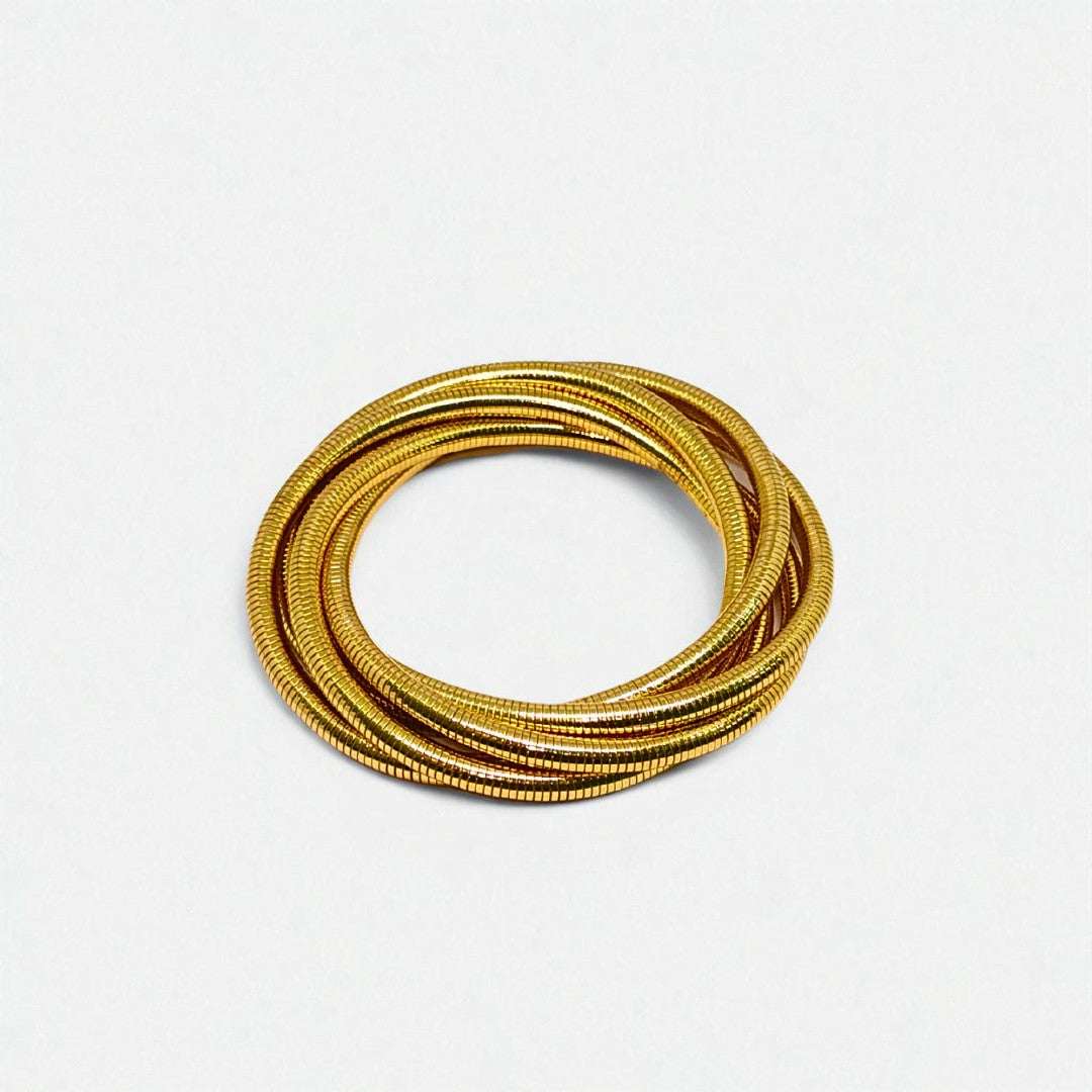 Gold Bracelet for Women on a wrist with a neutral background