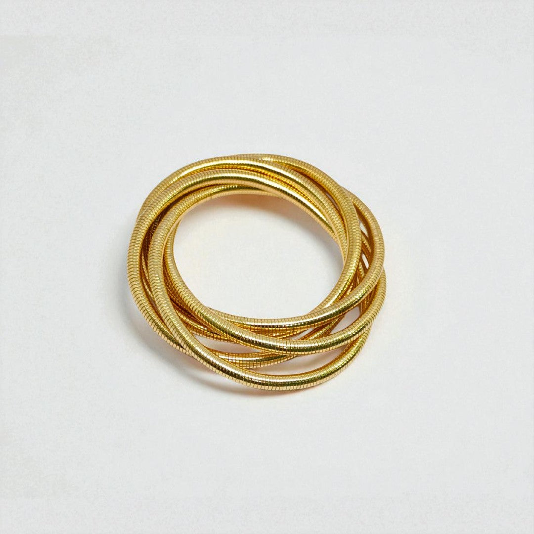 Gold Bracelet for Women stacked on a light gray background