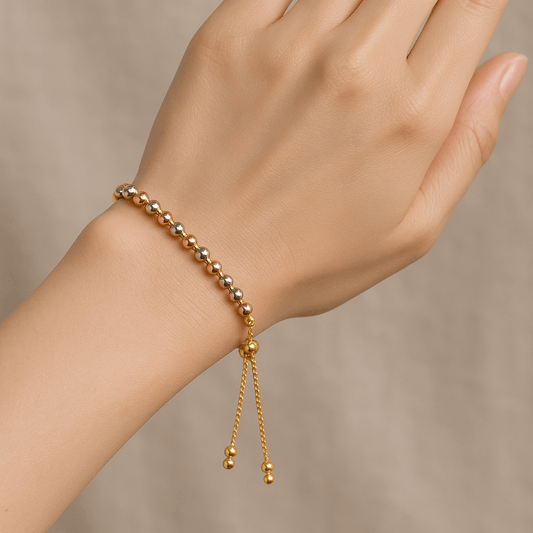 Gold Bracelet for Women on a hand against a neutral background