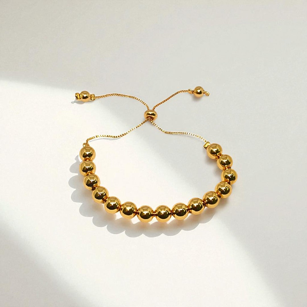 Gold Bracelet for Women on a wrist with a neutral background