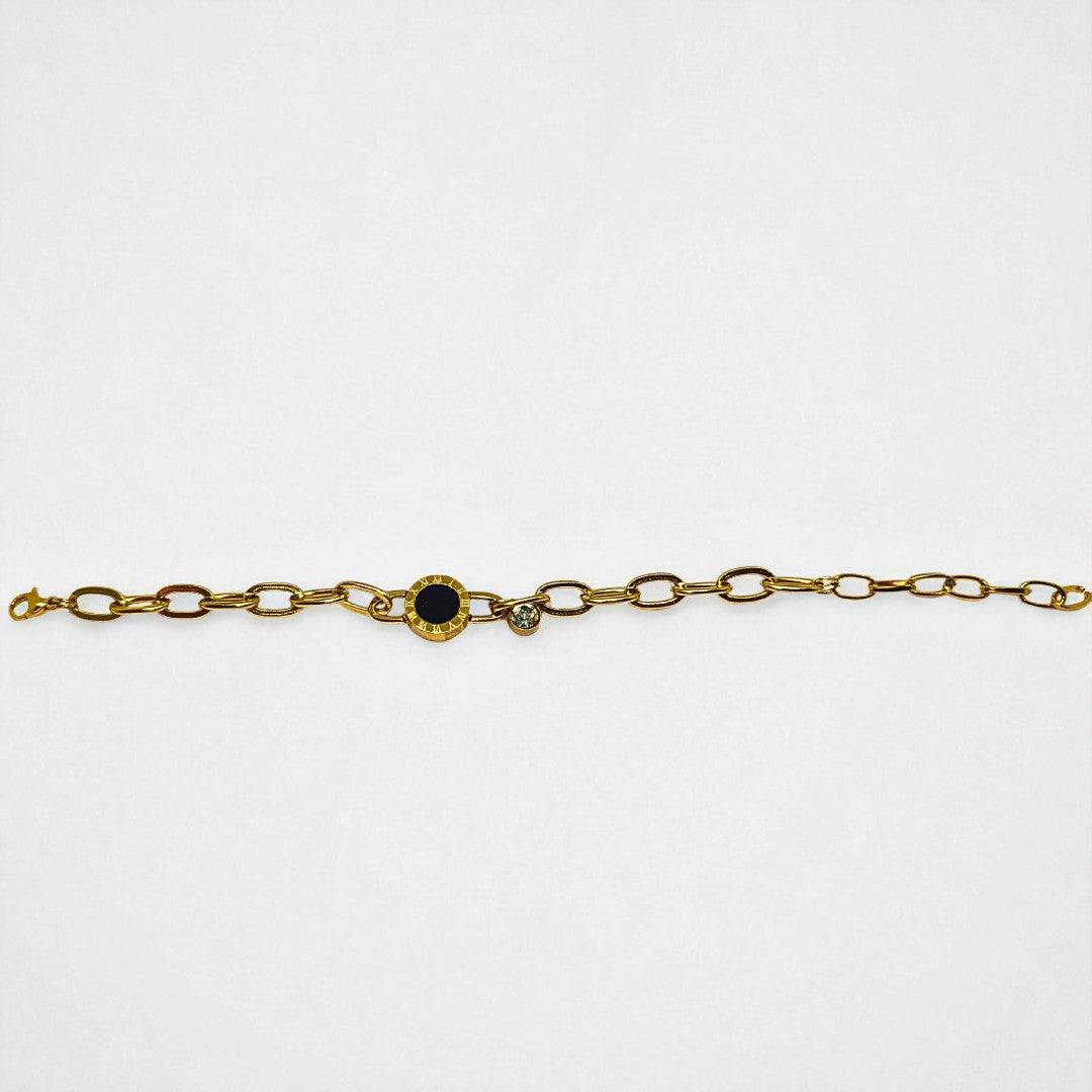 Gold Bracelet for Women with a black gemstone and smaller clear gemstones on a white background