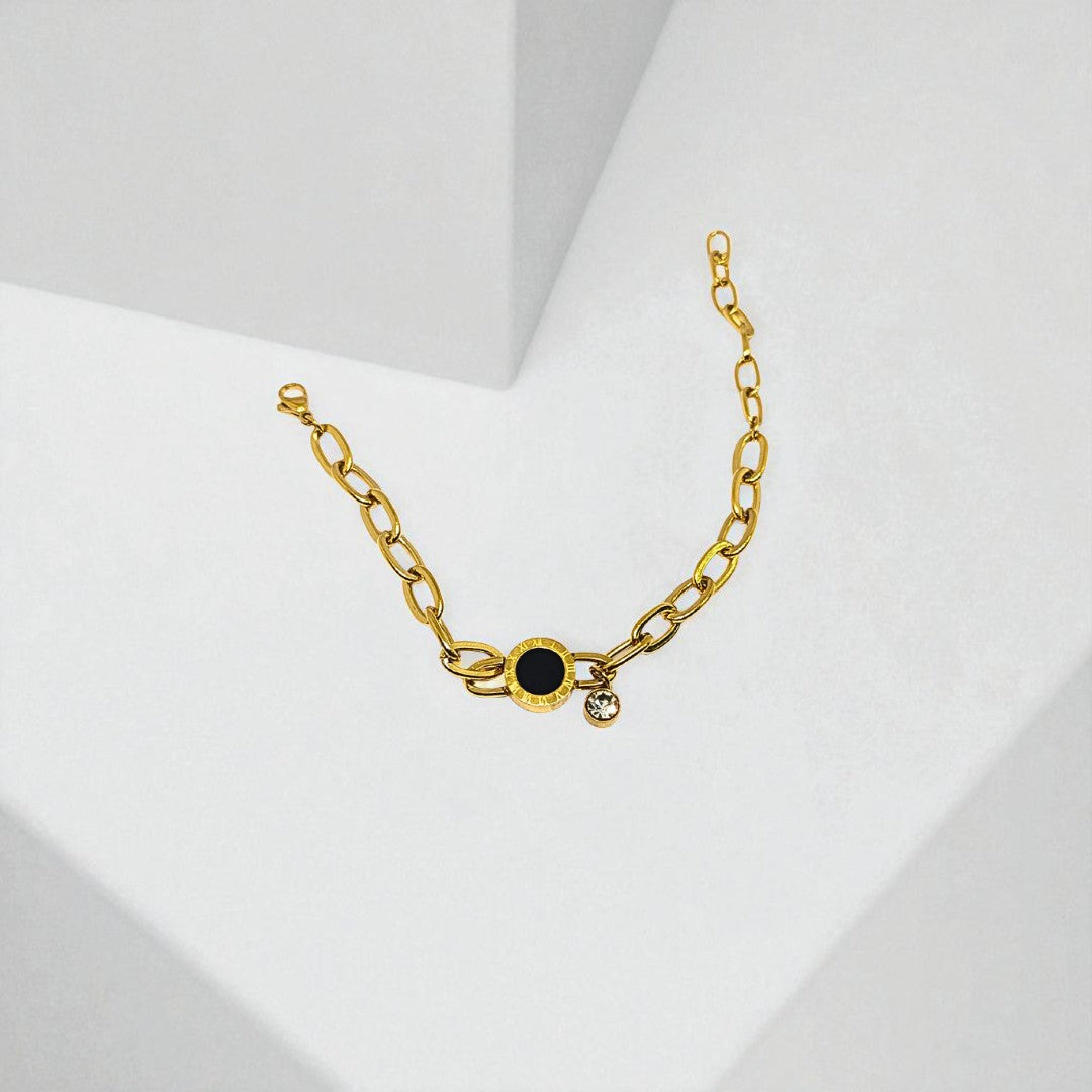 Gold Bracelet for Women with a black gemstone on a white background