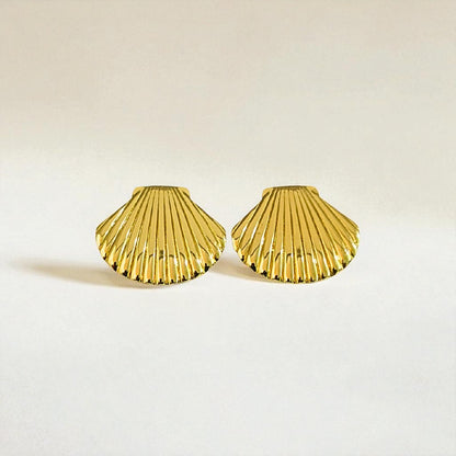 Gold shell-shaped Earrings for Women on a light beige background