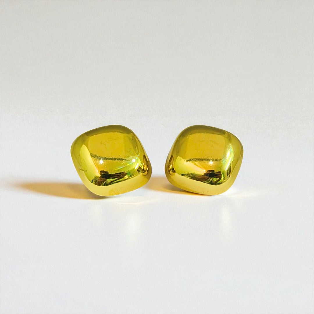 Pair of yellow gemstone Earrings for Women on a light gray background