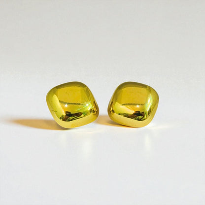 Pair of yellow gemstone Earrings for Women on a light gray background