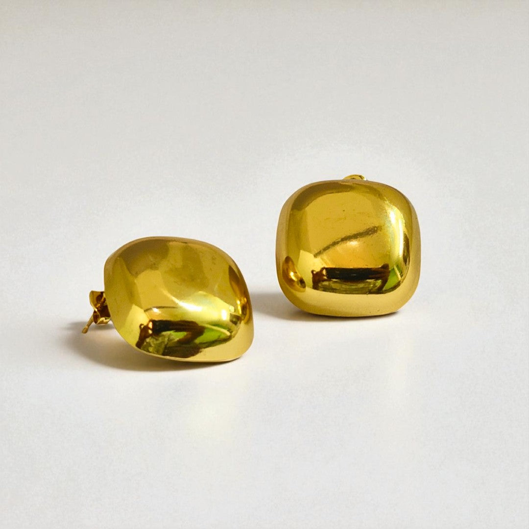 Pair of gold Earrings for Women on a light gray background