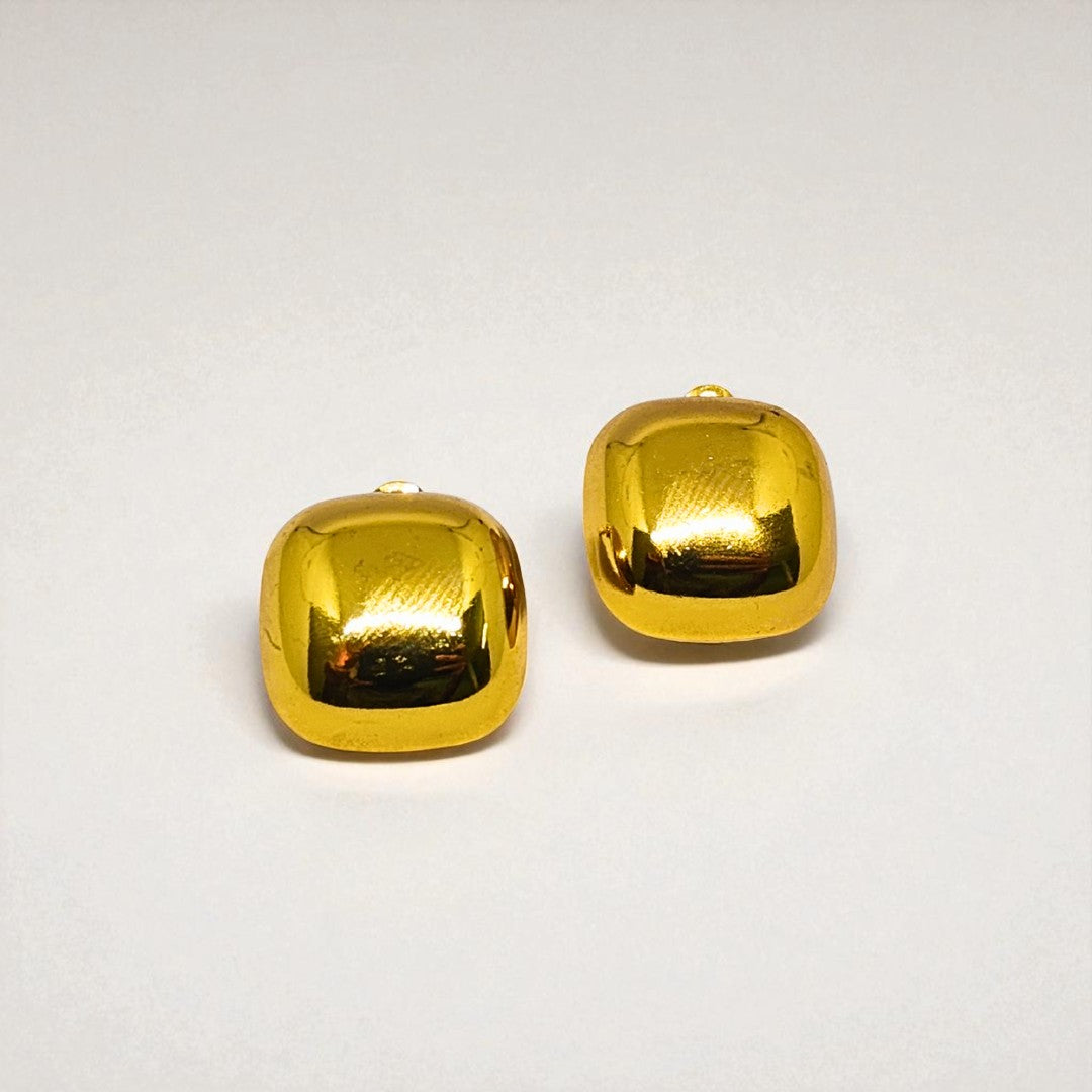 Pair of gold Earrings for Women on a light gray background