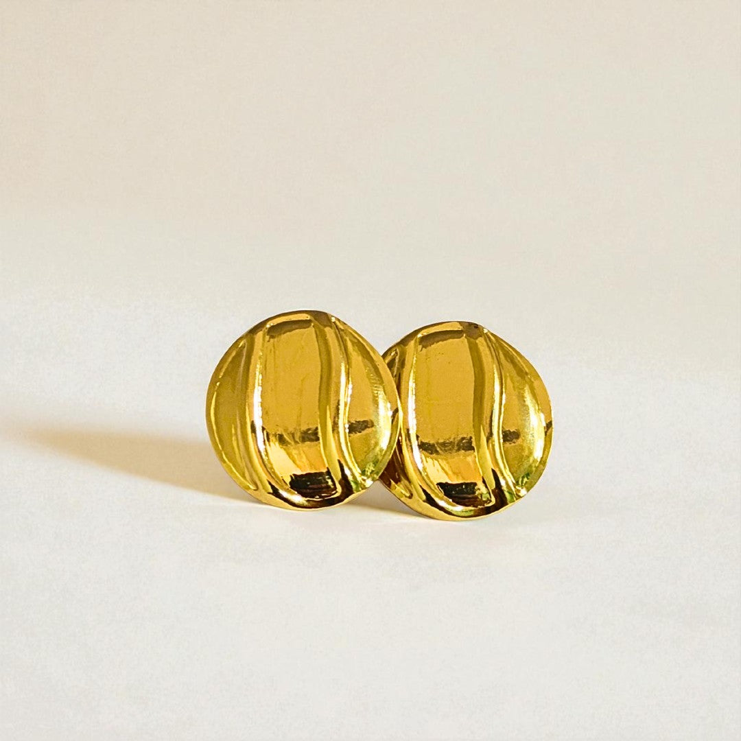 Pair of gold Earrings for Women on a light beige background