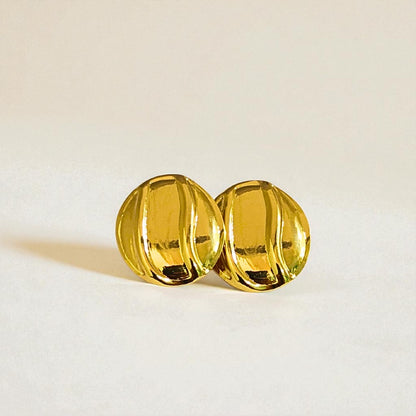 Pair of gold Earrings for Women on a light beige background