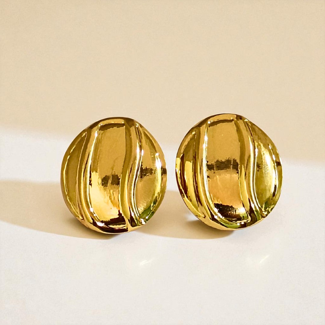 Pair of gold Earrings for Women on a beige background