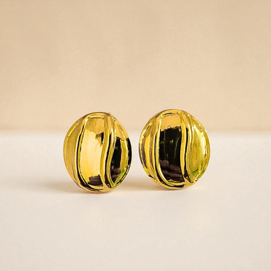Pair of gold Earrings for Women on a beige background