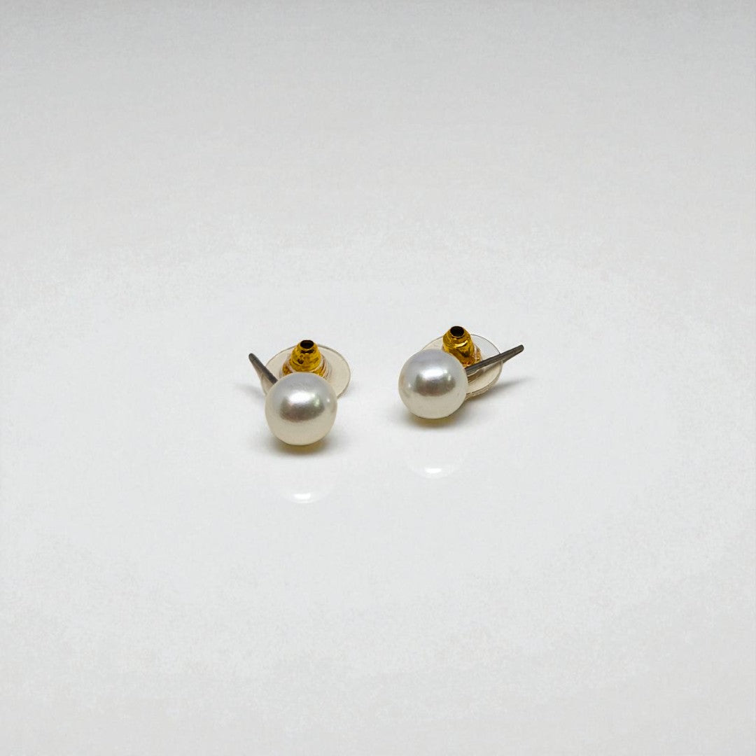 Pair of pearl stud earrings for women on a white background