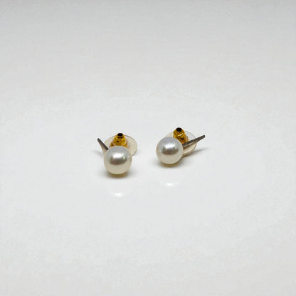 Pair of pearl stud earrings for women on a white background