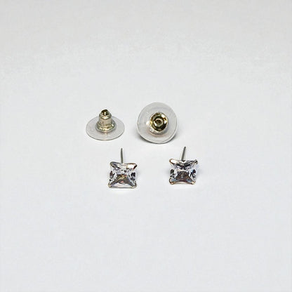 Pair of square crystal stud earrings for women with clear backs on a white background
