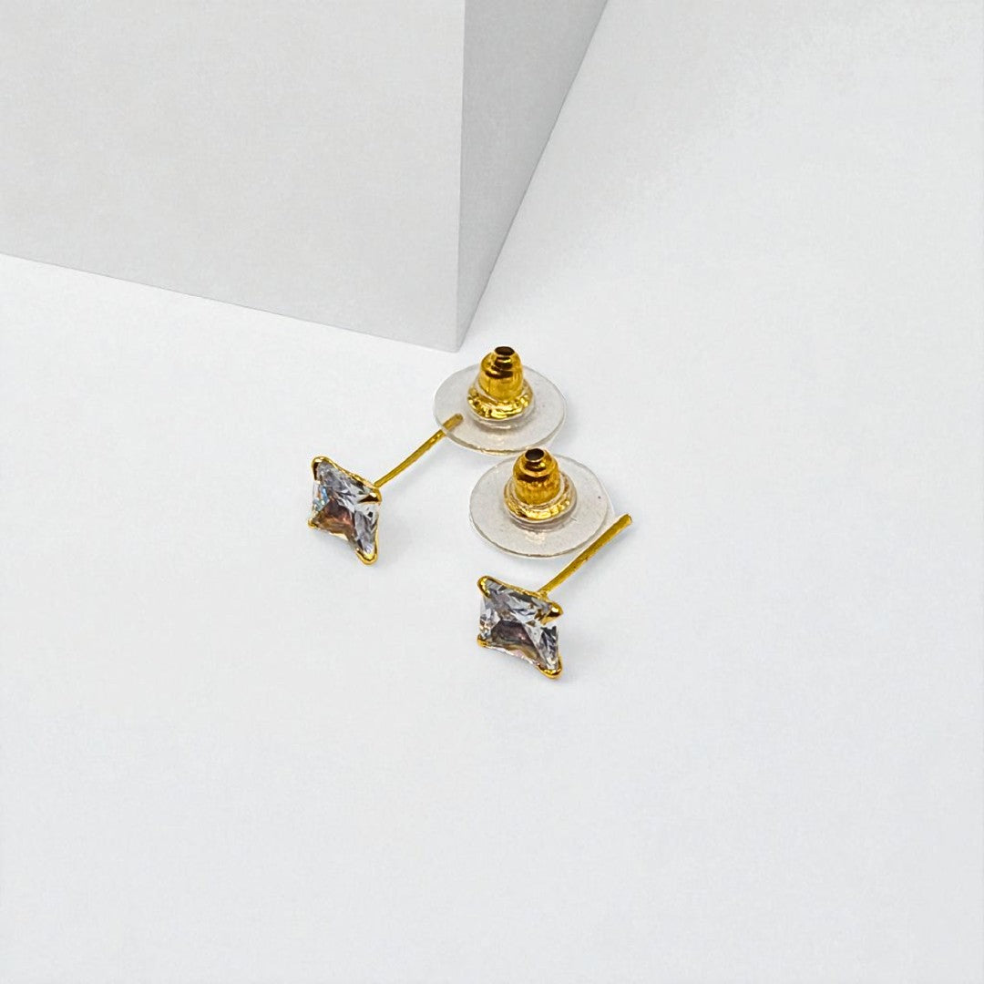 Gold Stud Earrings for Women with clear gemstones on a white background