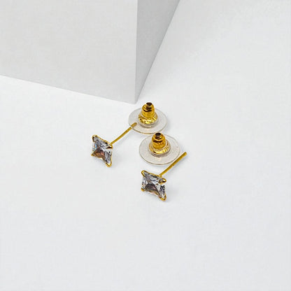 Gold Stud Earrings for Women with clear gemstones on a white background