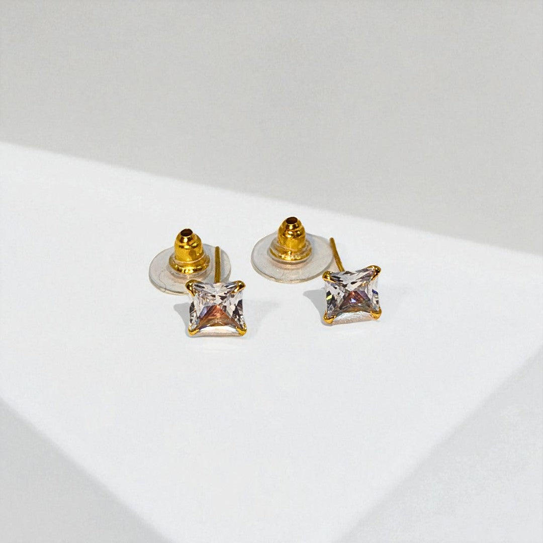 Pair of gold square Stud Earrings for Women on a light gray background