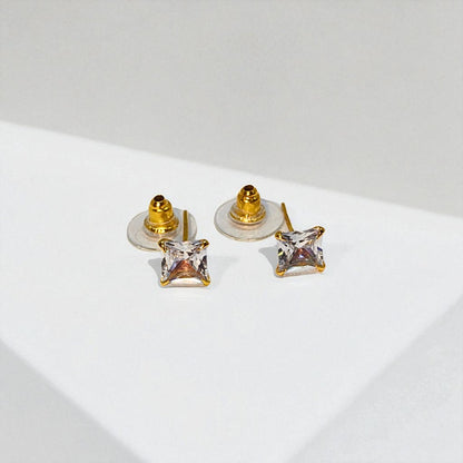 Pair of gold square Stud Earrings for Women on a light gray background
